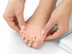 Realign toe separator worn on a bare foot
